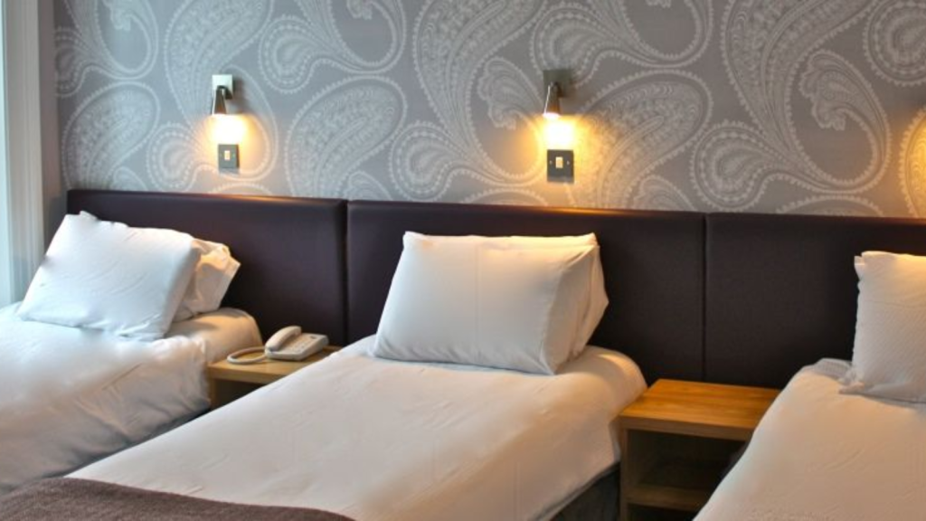 Three beds in a modern hotel room